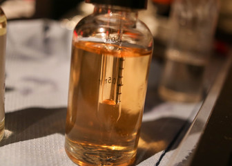 Vial full of viscous orange liquid