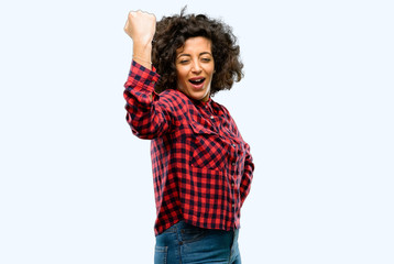 Beautiful arab woman happy and excited expressing winning gesture. Successful and celebrating victory, triumphant