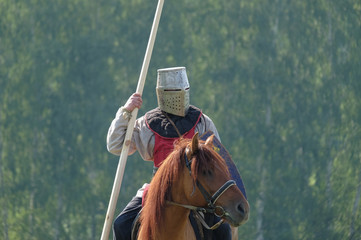 medieval knight with a spear riding a horse