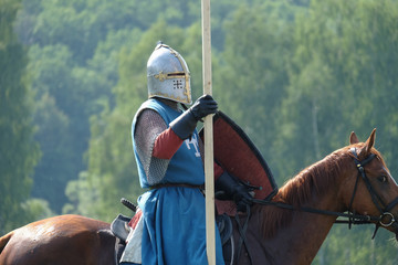 medieval knight with a spear riding a horse