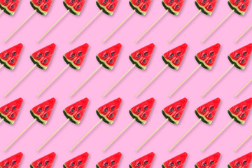 pattern of sweets in shape of watermelow on pink background. Minimal flat lay