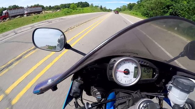POV speeding motorcycle, weaving in and out of traffic, very fast, GoPro helmet cam, 1080p 24 fps.