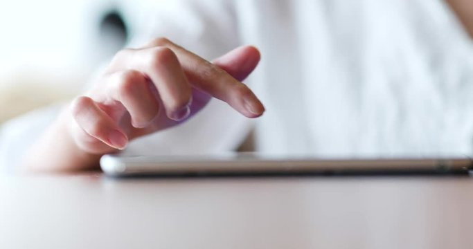 Woman hand touch on tablet and put it on the table