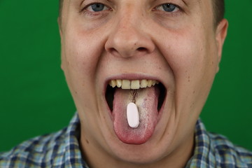 Young Man taking a pill