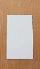 White Poster Frame with Copy Space Isolated on Empty Wooden Panel Background. Blank Template, Mock Up Design of Paper Page on the Wood Material Wall. Simple Border Frame of  Modern Note Canvas Banner.