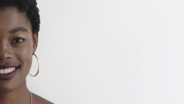 portrait of beautiful african american woman smiling wearing makeup cosmetics black female half face copy space