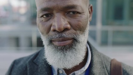 close up portrait of mature african american businessman leader looking up confident at camera smiling successful  - Powered by Adobe