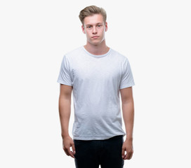 Obraz premium Young handsome blond man with a confident expression on smart face thinking serious