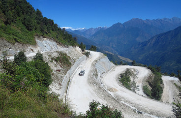 Long and winding dusty gravel road from Sekha to Num, Himalayan mountain region, eastern Nepal