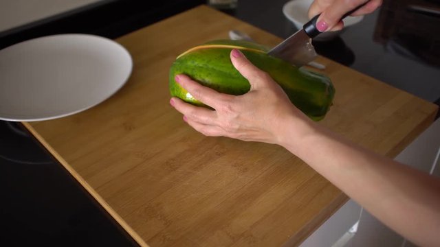Cutting papaya fruit with cheff knife