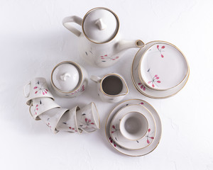 Set of old porcelain service isolated on white.Manufactured in 1962 in Riga.