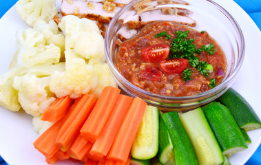 Tomato chili and Pickled fish paste in the east of Thailand with 3 mixed color from vegetable and Fried Pork..Northeastern Thai menu set.
