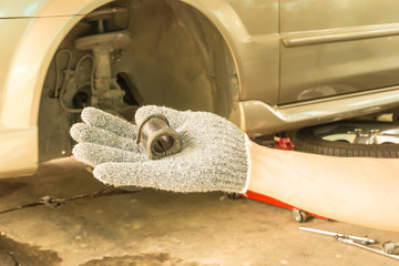 Hand with Car suspension stabilizer bush.