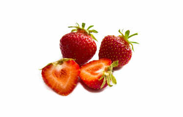 Strawberry with sliced half and leaves isolated on white background with clipping path. Strawberry whole and cut into halves. Close-up. Red strawberries.