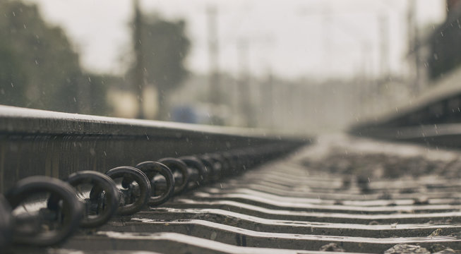 Rain drops broke on the rail. The photo symbolizes nostalgia and loneliness.