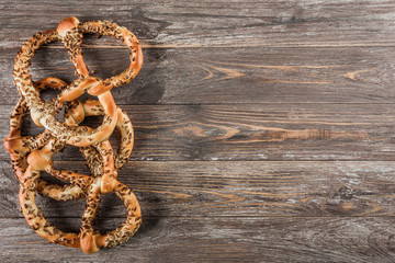 Three pretzels, on wood background, text space