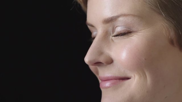 close up young blonde woman smiling cheerful healthy perfect skin beautiful caucasian woman on black background 