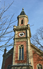 Fototapeta na wymiar Clock tower Church in Salzburg Austria