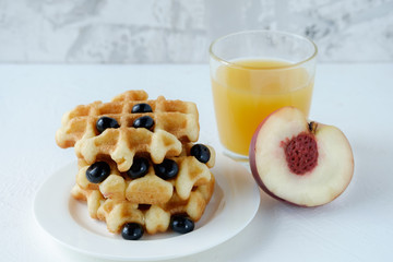 Belgian waffles and slices of nectarine