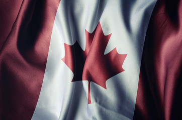 Canada flag with cloth texture, retro background effect.