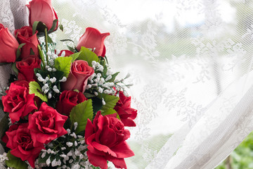 Red rose bouquet with white lace curtain