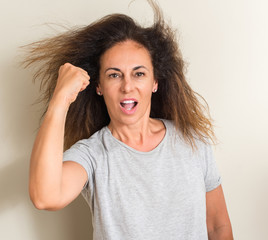 Curled hair brazilian woman annoyed and frustrated shouting with anger, crazy and yelling with raised hand, anger concept