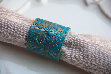Turquoise and Gold vintage napkin ring on beautiful plate. Part of table for wedding preparation or romantic evening.