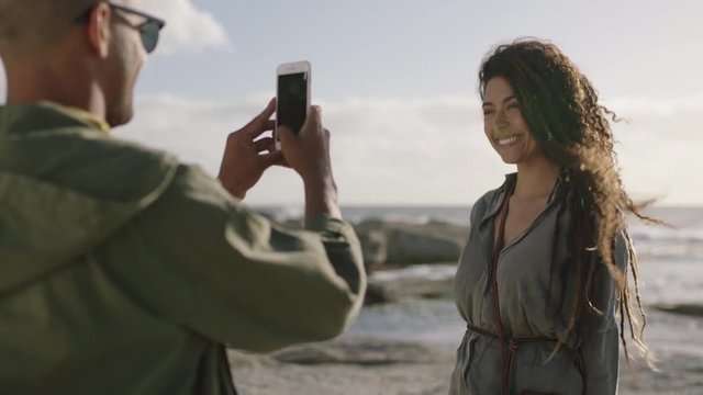 beautiful mixed race woman posing for photo couple taking photos at beach