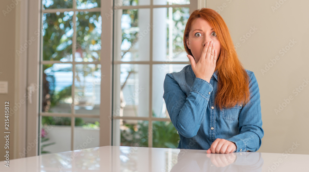 Sticker redhead woman at home cover mouth with hand shocked with shame for mistake, expression of fear, scar