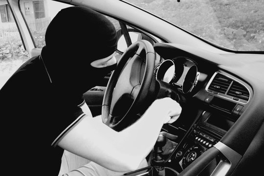 The malefactor in the mask stealing car in b/w