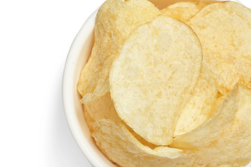 Delicious golden potato chips in a white bowl isolated on white background close-up.