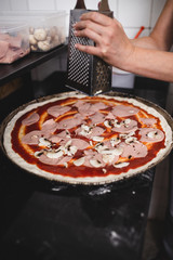 Close up shot of pizza making or preparing process