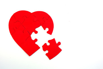 Red heart puzzle with a missing piece