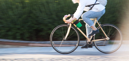 girl on a bicycle in a city park