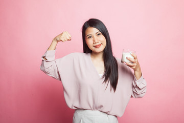 Healthy Asian woman drinking a glass of milk.