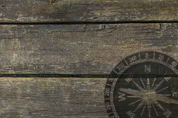 wooden background with a picture of a compass