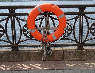 Orange lifebuoy on the embankment in Riga