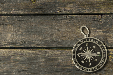 Compass on an old wooden background.