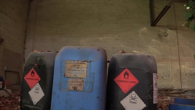 dangerous and toxic barrels left behind in an abandoned building