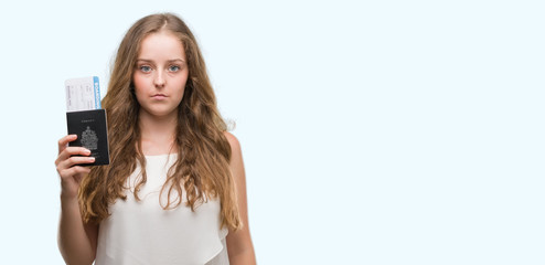 Fototapeta premium Young blonde woman holding passport of canada and boarding pass with a confident expression on smart face thinking serious