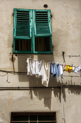 Washing day in Certaldo, Tuscany; Shuttered window and drying clothes