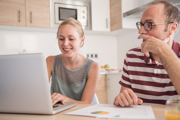 Couple sitting at a table in a kitchen