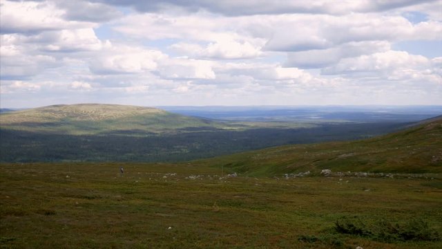 Hikers in the distant with mountains in the background in Dalarna, Sweden