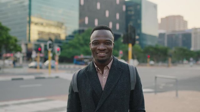 portrait of confident young african american businessman smiling looking at camera cheerful successful enjoying urban lifestyle