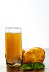 glass of potato juice on wooden table on white background with copy space.