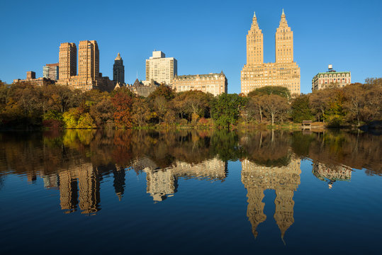 Skyline of Manhattan reflected in a pond in central park at sunrise, New York, United States of America