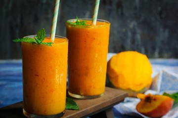 Mango Peach frozen drink or smoothieserved in tall glass, selective focus
