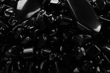 Fototapeta na wymiar Decorative women's beads of black stones close-up. Abstract background