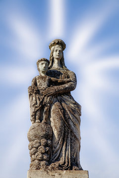 Ancient statue of the Virgin Mary with Jesus Christ in the rays of fame