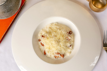 Close-up risotto with chanterelle mushrooms and grated parmesan, top view
